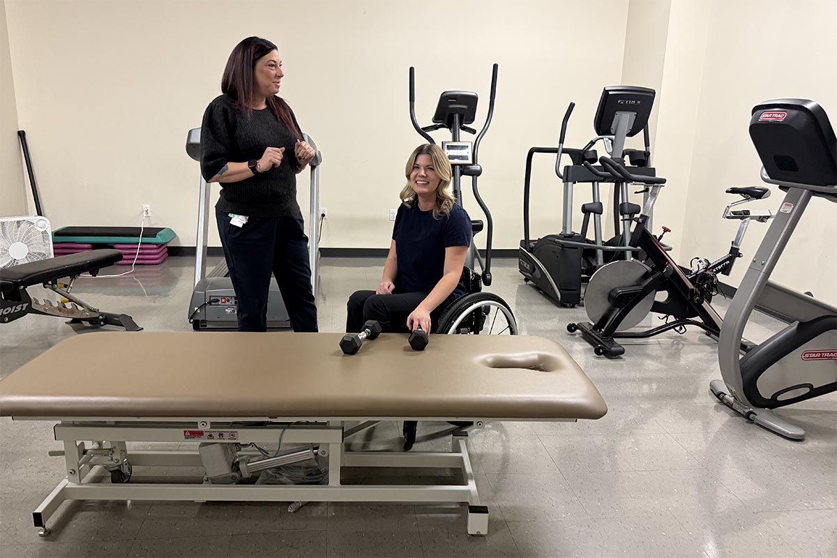 Two adults in a gym setting