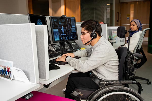 Two young workers with disabilities at work at Holland Bloorview