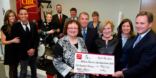 Donor presenting a cheque to staff.