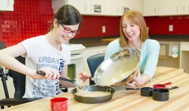 Emma and Kristen cooking