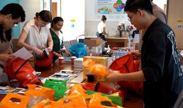 Some adults are preparing some bags to give them to kids