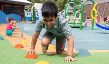 Some children are playing in the outdoor playground