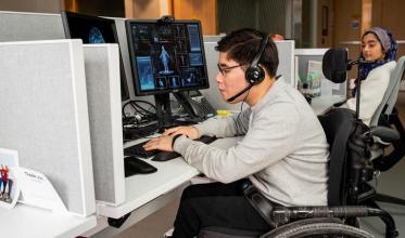 Two adults in a call centre