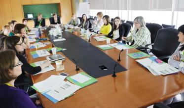 Faculty sitting in a boardroom