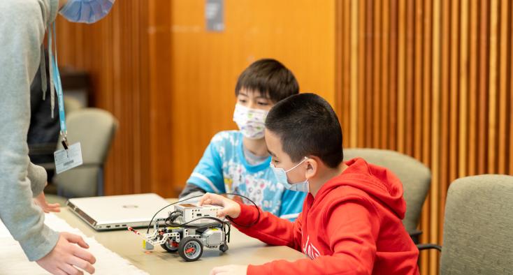 two boys sitting at a table