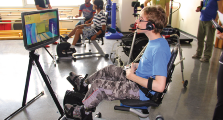 Child pedaling on recumbent bike and holding game controller to play video game on a screen.