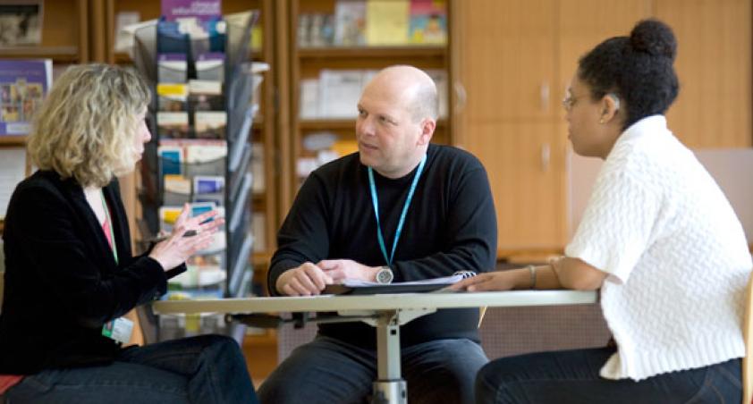 2 women and 1 man in a discussion