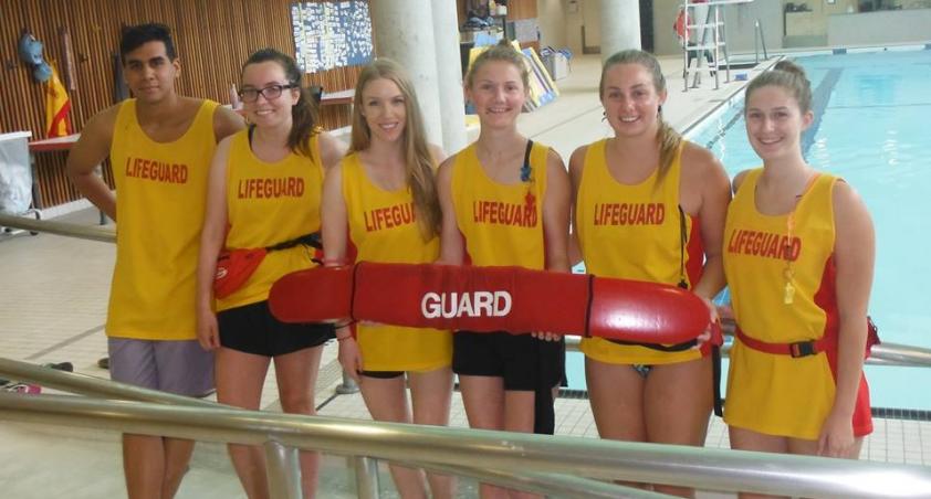 Aquatics staff hanging out by the pool
