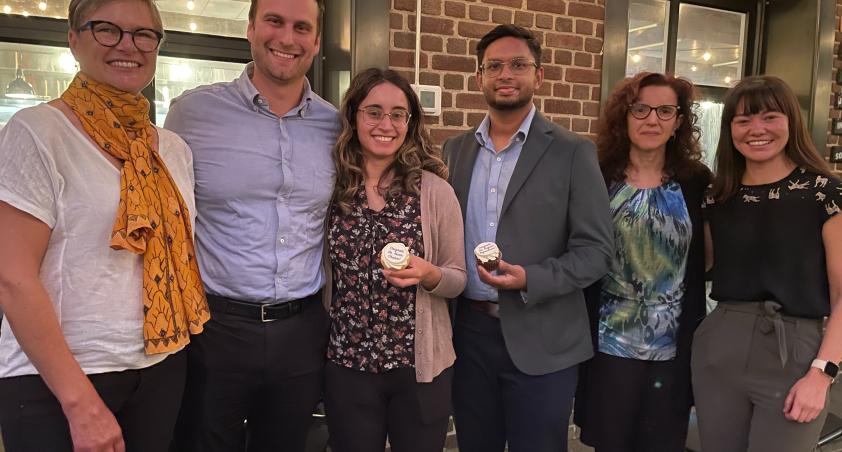 A group of adults standing in an indoor setting