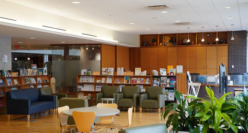 A library setting with some spare coffee tables and chairs