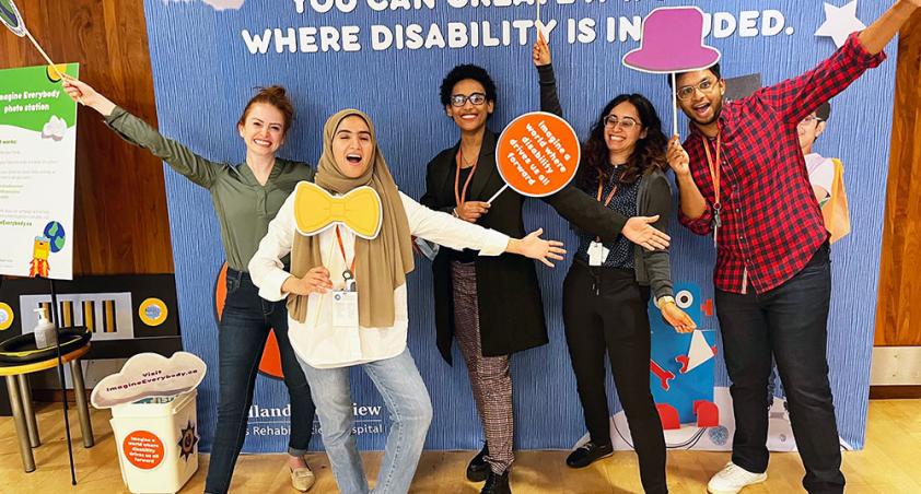 A group of adults holding some pops with fun pose