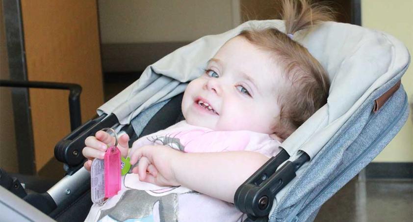 A baby sitting on a car seat