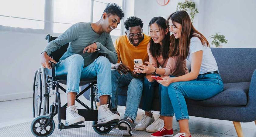 Some adults sitting together to read from a mobile phone