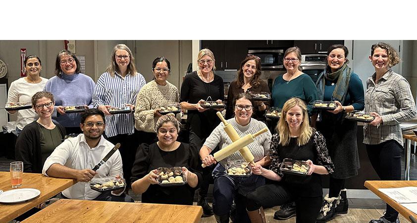 A group of adults having a pot-luck party