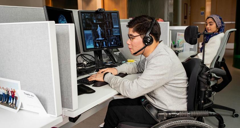 Two adults working in a call centre