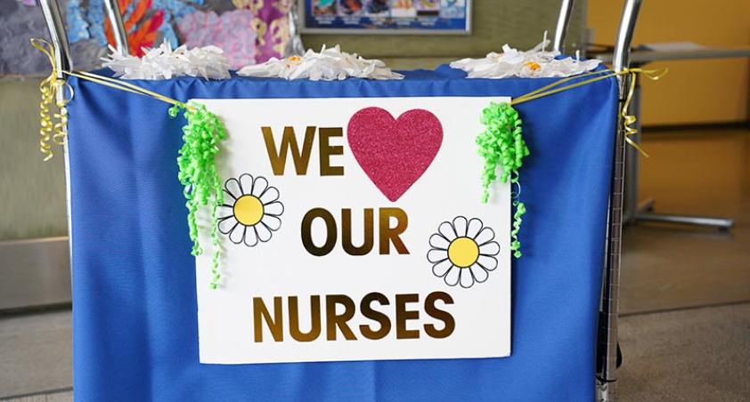 A banner with "we love our nurses" in front of a table