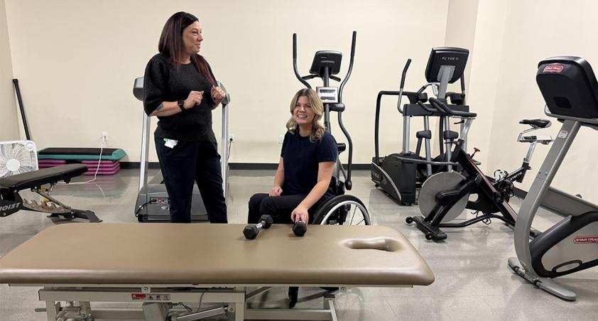 Two adults in a gym setting