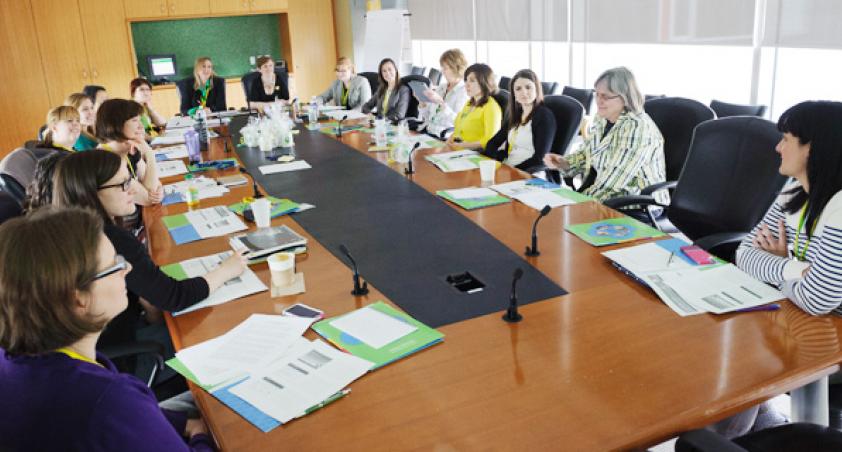 Staff having a meeting around a boardroom table