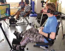 Child pedaling while playing a Liberi mini game on a tablet