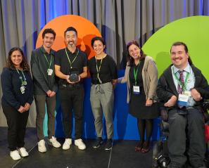 A group of people receiving an award on a stage