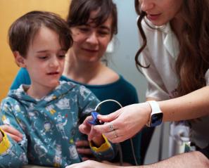 A child is having a test by clinical staff