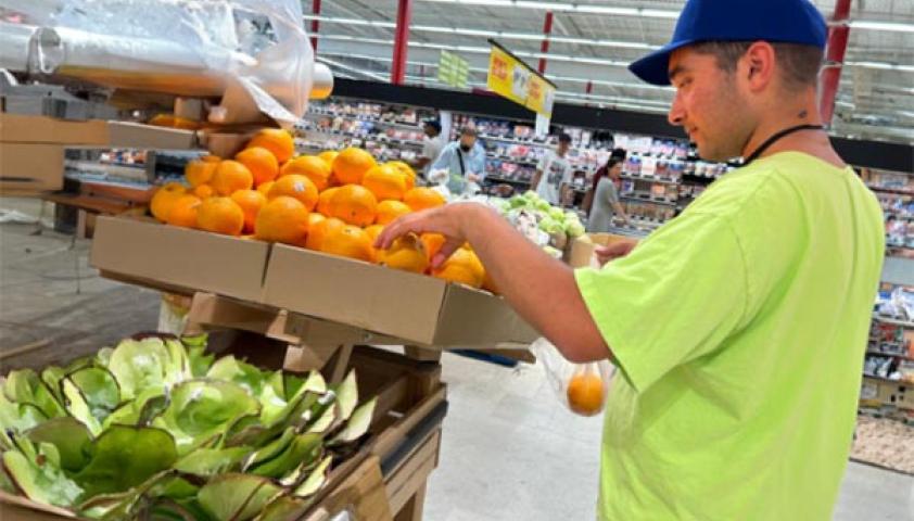 A teenager is shopping in a grocery store