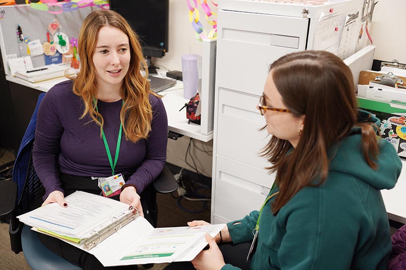 Two adults having a meeting in an office