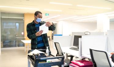 A staff with mask on working in a hospital setting