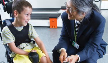 Tom Chau with a boy in a wheelchair