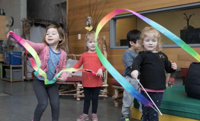 Kids waving rainbows