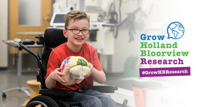 boy holding brain toy and logo