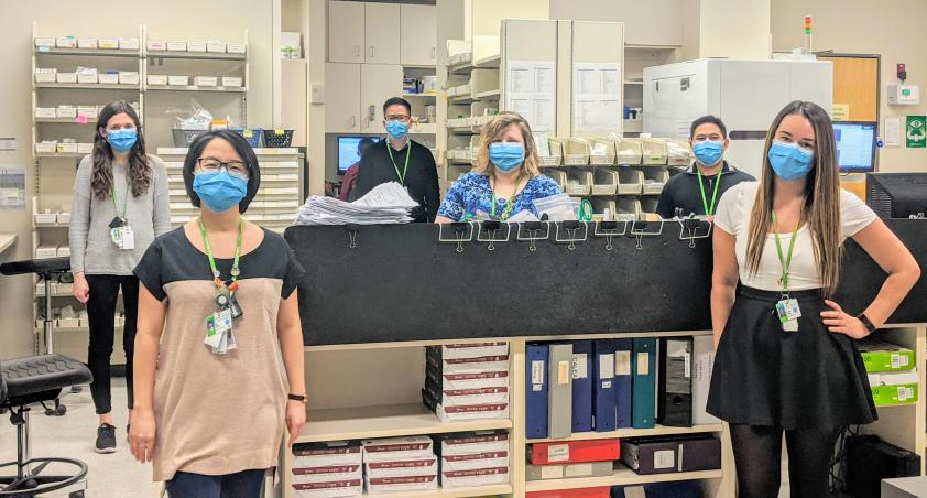 Members of our pharmacy blue team in the pharmacy with masks on