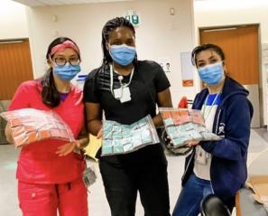 Nurses holding a delivery of brownies.