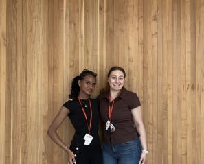 Two female students standing and posing for a photo