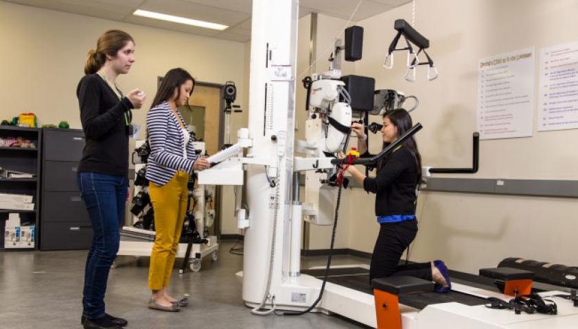 Three women prepare a large machine