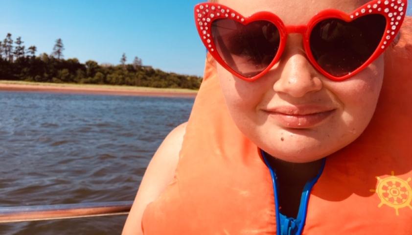 Scarlet wearing sunglasses on the water.