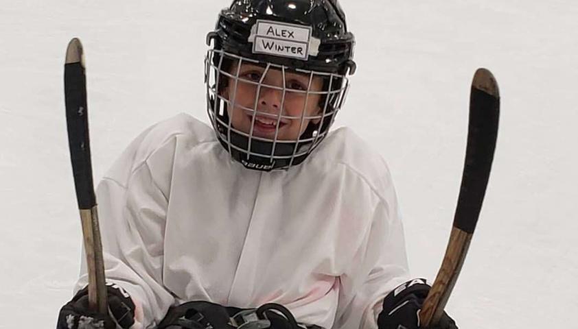 Alex playing sledge hockey. 