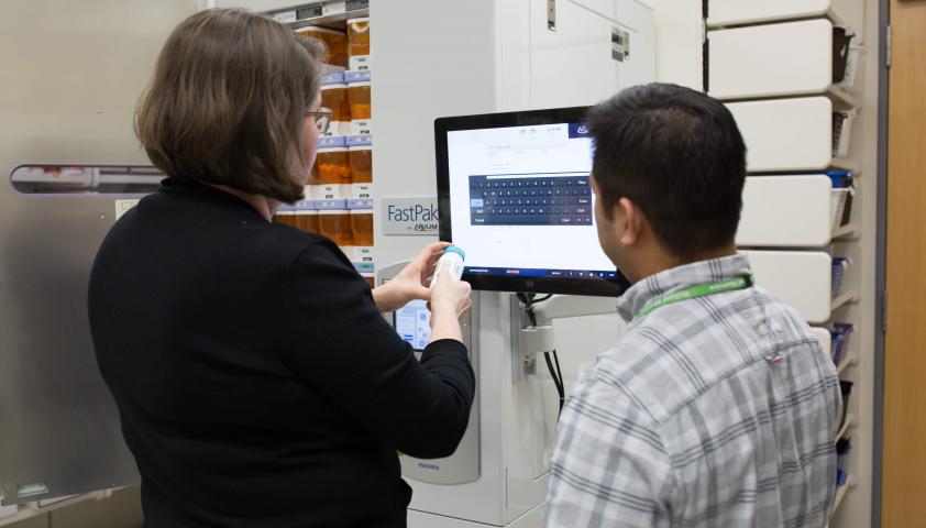 Pharmacists using the Elite FastPak machine.