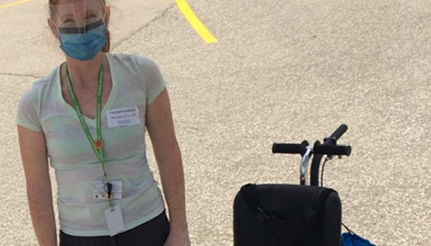 Kristen outside with an adapted bike.