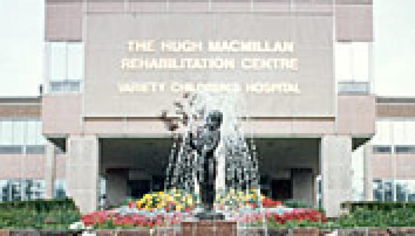 Photo of the entrance of a building with a fountain in front of it