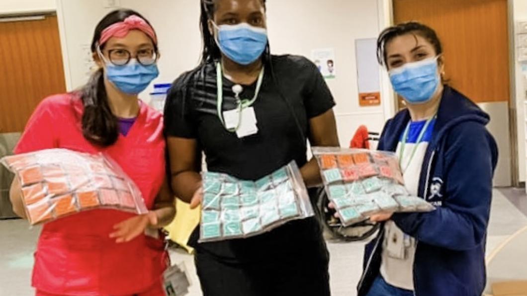 Nurses holding a delivery of brownies.
