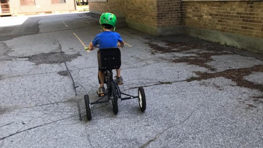 Child pedalling on his bike.