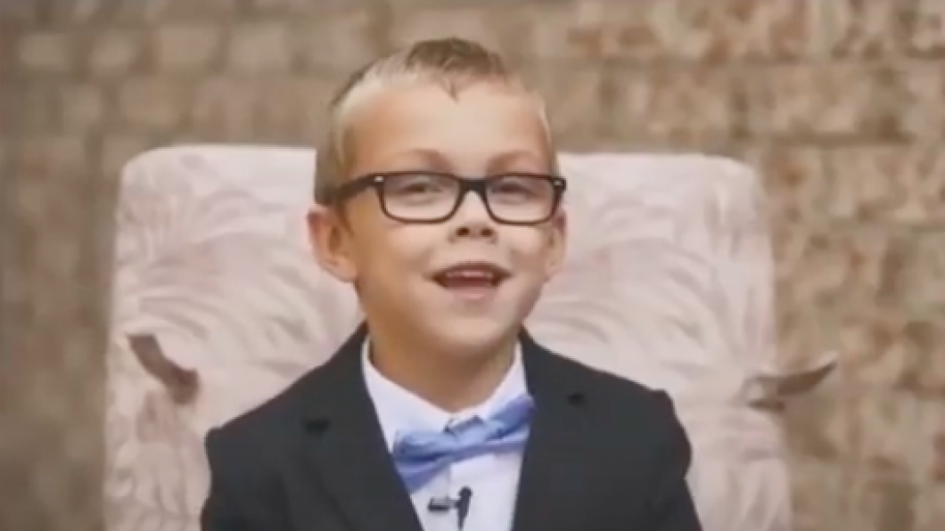 Alex smiling at the camera with his blue bowtie. 